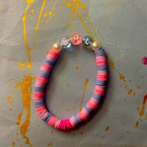 This is a blue pink and purple clay beaded bracelet. It has lol for funny girlys